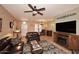 Open living room with tile floors, and a built-in entertainment center with fireplace at 17630 N Somerset Dr, Surprise, AZ 85374