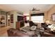 Warm living room featuring tile flooring, a ceiling fan, and a fireplace at 17630 N Somerset Dr, Surprise, AZ 85374