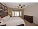 Inviting bedroom with carpet floors, a ceiling fan, and backyard views at 17630 N Somerset Dr, Surprise, AZ 85374