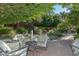 Relaxing outdoor seating area with plush chairs overlooking a tranquil water feature with lush greenery at 17630 N Somerset Dr, Surprise, AZ 85374