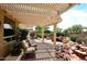 Covered patio featuring an outdoor dining area and beautiful landscaping that provides a serene retreat at 17630 N Somerset Dr, Surprise, AZ 85374