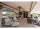 Covered patio with ceiling fans, various seating options, and outdoor décor at 17630 N Somerset Dr, Surprise, AZ 85374