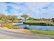 Scenic golf course pond and walking path, enhanced by lush foliage and reflective water at 17630 N Somerset Dr, Surprise, AZ 85374