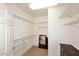 Spacious walk-in closet with ample shelving and carpeted floor, offering plenty of storage at 17630 N Somerset Dr, Surprise, AZ 85374