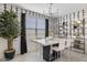 Modern dining area with a marble-top table, decorative wallpaper, and bright natural light at 17731 W Onyx Ave, Waddell, AZ 85355