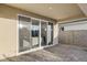 Covered patio with sliding glass doors leading to a tastefully decorated interior living space at 17731 W Onyx Ave, Waddell, AZ 85355