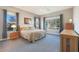 Inviting bedroom with neutral walls, plush carpet, large windows, and warm natural light at 17900 W Briarwood Dr, Goodyear, AZ 85338