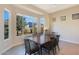 Elegant dining room with a large window offering natural light and a view of the outdoors at 17900 W Briarwood Dr, Goodyear, AZ 85338