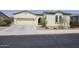 Charming single-story home with a well-maintained lawn, desert landscaping, and attached garage at 17900 W Briarwood Dr, Goodyear, AZ 85338