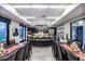Large community kitchen features black cabinets, island with seating, stainless steel appliances, and spacious tables at 17900 W Briarwood Dr, Goodyear, AZ 85338