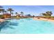 Stunning community pool with ample seating, covered lounge area, and lush landscaping for relaxation and enjoyment at 17900 W Briarwood Dr, Goodyear, AZ 85338