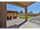 Inviting backyard patio with outdoor seating area and well manicured lawn at 18047 W Caribbean Ln, Surprise, AZ 85388