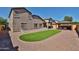 Backyard with manicured lawn, patio, gazebo and protective pet fence at 18047 W Caribbean Ln, Surprise, AZ 85388