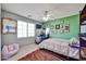 Comfortable bedroom with ceiling fan, natural light, and quirky decor for a personalized touch at 18047 W Caribbean Ln, Surprise, AZ 85388