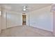 Bright bedroom with carpet, ceiling fan, closet, and neutral palette providing a blank canvas for personalization at 18047 W Caribbean Ln, Surprise, AZ 85388