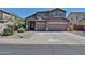 Charming two-story home features a spacious three-car garage and well-maintained landscaping at 18047 W Caribbean Ln, Surprise, AZ 85388