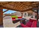 Gazebo in backyard features outdoor furniture, a gas firepit and TV at 18047 W Caribbean Ln, Surprise, AZ 85388