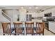 Bright kitchen features granite countertops, stainless steel appliances, and an island with bar seating at 18047 W Caribbean Ln, Surprise, AZ 85388
