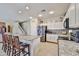 Open kitchen featuring granite countertops, stainless steel appliances, and a breakfast bar at 18047 W Caribbean Ln, Surprise, AZ 85388