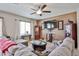 Inviting living room with ceiling fan, and comfortable seating perfect for relaxation and entertaining at 18047 W Caribbean Ln, Surprise, AZ 85388