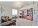 Welcoming living room with large window, elegant furniture, and decorative shelving for a cozy ambiance at 18047 W Caribbean Ln, Surprise, AZ 85388