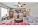 Inviting living room with ceiling fan, and comfortable seating perfect for relaxation and entertaining at 18047 W Caribbean Ln, Surprise, AZ 85388
