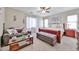 Comfortable main bedroom with ceiling fan, sitting area, and abundant natural light from the surrounding windows at 18047 W Caribbean Ln, Surprise, AZ 85388