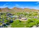 Aerial image showcasing a vibrant community park, playground, and green space with a backdrop of mountains at 1806 W Fetlock Trl, Phoenix, AZ 85085