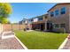 Spacious backyard with artificial turf, outdoor seating, grill, and privacy fence at 1806 W Fetlock Trl, Phoenix, AZ 85085