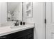 Clean bathroom with a white countertop, dark cabinetry, and a modern faucet and mirror at 1806 W Fetlock Trl, Phoenix, AZ 85085