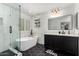 Modern bathroom boasts a glass shower, soaking tub, and stylish black and white design at 1806 W Fetlock Trl, Phoenix, AZ 85085
