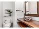 Charming half-bath with colorful sink, wooden shelves, and sleek black fixtures at 1806 W Fetlock Trl, Phoenix, AZ 85085