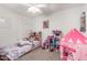 Cozy bedroom with plush bed, dollhouse, and tent providing a fun and imaginative space at 1806 W Fetlock Trl, Phoenix, AZ 85085