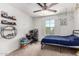 Bright bedroom with large window, ceiling fan, and comfortable furnishings, ideal for relaxation at 1806 W Fetlock Trl, Phoenix, AZ 85085