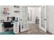 Bedroom featuring a white desk with drawers, tiled flooring, and double doors opening into the hall at 1806 W Fetlock Trl, Phoenix, AZ 85085