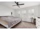 Spacious bedroom with plantation shutters, a ceiling fan, and neutral carpet and paint at 1806 W Fetlock Trl, Phoenix, AZ 85085