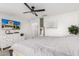 Bedroom with white dresser, ceiling fan, and TV, offering a comfortable and modern living space at 1806 W Fetlock Trl, Phoenix, AZ 85085