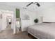 Bright bedroom featuring a ceiling fan, neutral-toned walls, and a full-length mirror at 1806 W Fetlock Trl, Phoenix, AZ 85085