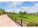 Picturesque community park view featuring a walking path and a shaded playground amidst lush greenery at 1806 W Fetlock Trl, Phoenix, AZ 85085