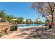 Community pool area with lounge chairs and sunshades, complete with surrounding landscaping at 1806 W Fetlock Trl, Phoenix, AZ 85085