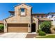 Charming two-story home with a well-manicured lawn, a brown door, and a two-car garage at 1806 W Fetlock Trl, Phoenix, AZ 85085