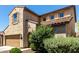 Charming two-story home with a well-manicured lawn, a brown door, and a two-car garage at 1806 W Fetlock Trl, Phoenix, AZ 85085