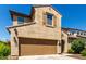 Charming two-story home with a well-manicured lawn, a brown door, and a two-car garage at 1806 W Fetlock Trl, Phoenix, AZ 85085