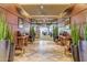 Welcoming hallway with tiled floors, accent lighting, and potted snake plants leading to the sitting area at 1806 W Fetlock Trl, Phoenix, AZ 85085