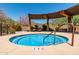 A community hot tub with seating and a shade structure set against a mountain backdrop at 1806 W Fetlock Trl, Phoenix, AZ 85085
