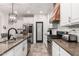 Modern kitchen boasts granite countertops, stainless steel appliances, white cabinets, and a stylish black accent door at 1806 W Fetlock Trl, Phoenix, AZ 85085