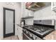Close up of kitchen featuring stainless steel gas range and custom backsplash at 1806 W Fetlock Trl, Phoenix, AZ 85085