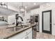 Bright kitchen showcasing granite countertops, a stainless steel dishwasher, and an elegant modern lighting fixture at 1806 W Fetlock Trl, Phoenix, AZ 85085