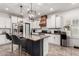 Spacious kitchen features an island with granite countertop, stainless steel appliances, and a modern lighting fixture at 1806 W Fetlock Trl, Phoenix, AZ 85085