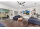 Spacious living room features dark floors, a ceiling fan, and a custom entertainment center at 1806 W Fetlock Trl, Phoenix, AZ 85085